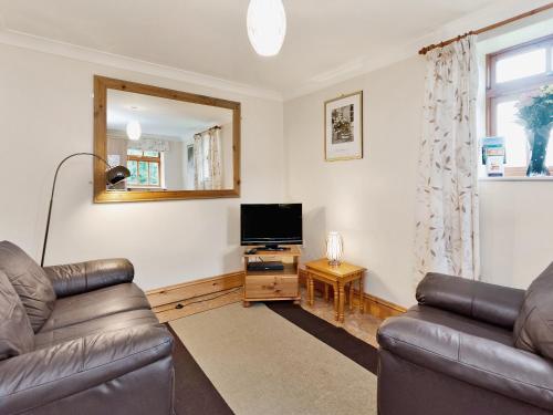 a living room with two leather couches and a television at Trueman - W41948 in Filey