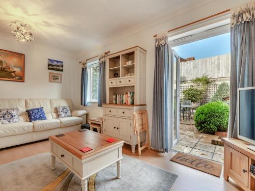 a living room with a couch and a table at Chaucer Rise in Exmouth