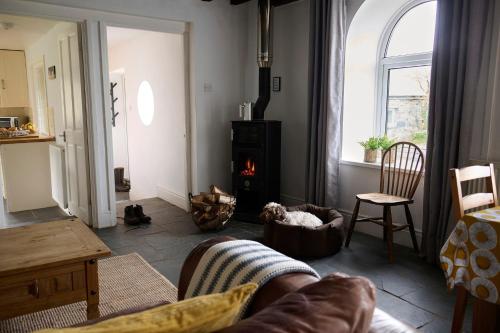 a living room with a couch and a fire place at Granary - Ukc4684 in Clynnog-fawr