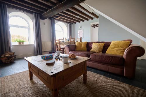 a living room with a couch and a coffee table at Granary - Ukc4684 in Clynnog-fawr