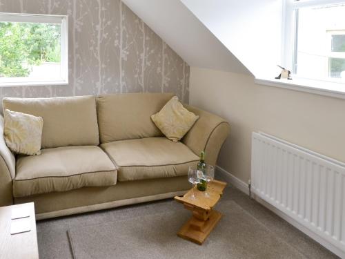 a living room with a couch and a table at The Smithy in Ovingham