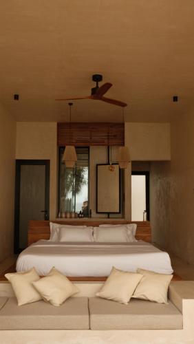 a bedroom with a large white bed with a ceiling at Neem - Boutique Hotel Madiha - ADULTS ONLY in Kamburugamuwa
