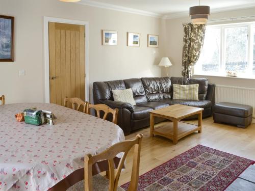 a living room with a couch and a table at Heatherlea in Otterburn