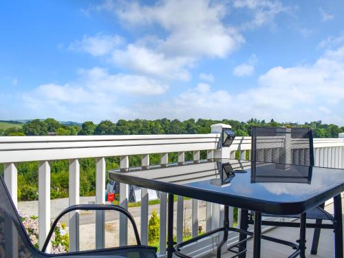 a balcony with a table and chairs on a railing at Valley View - Uk50320 in Liskeard