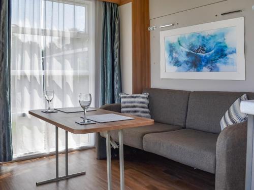a living room with a couch and a table with wine glasses at Valley View - Uk50320 in Liskeard
