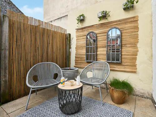 two chairs and a table on a patio at Surf Cottage in Cromer