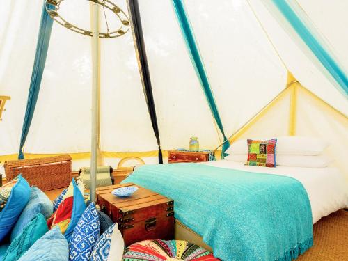 a bedroom with a tent with a bed and pillows at Moroccan - Ukc5930 in Highclere