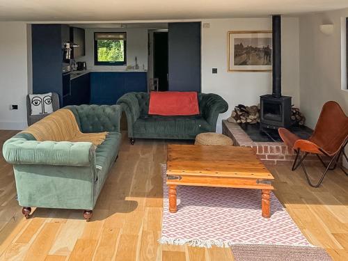 a living room with two couches and a coffee table at Fernhill Stables in Sevenoaks