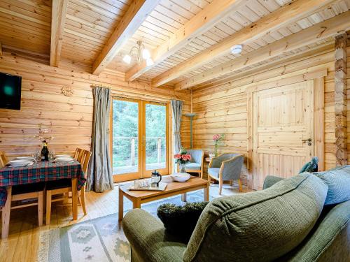 a living room with a couch and a table at Larch - Uk31134 in Killin