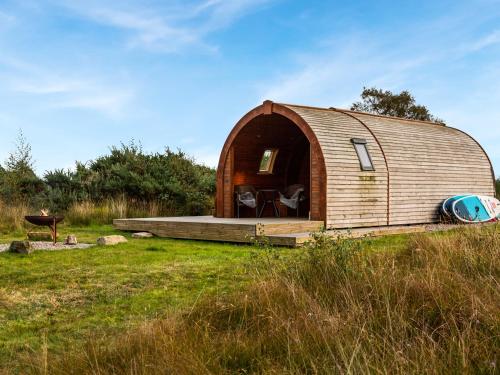 a wooden hobbit house in the middle of a field at Here - Uk50566 in Port of Menteith