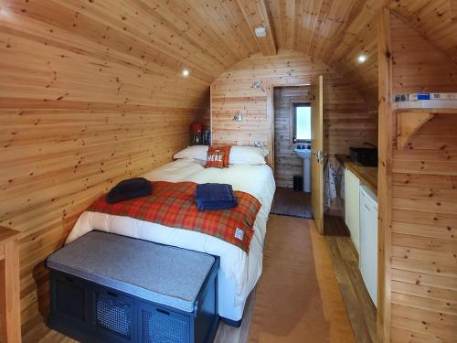 a bedroom with a bed in a log cabin at Here - Uk50566 in Port of Menteith