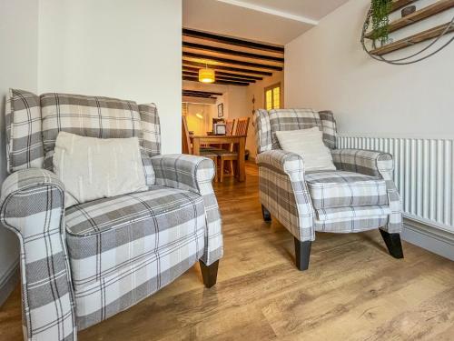 two chairs and a couch in a living room at Return Again in Beaumaris