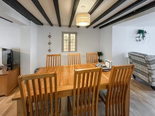 a dining room with a wooden table and chairs at Return Again in Beaumaris