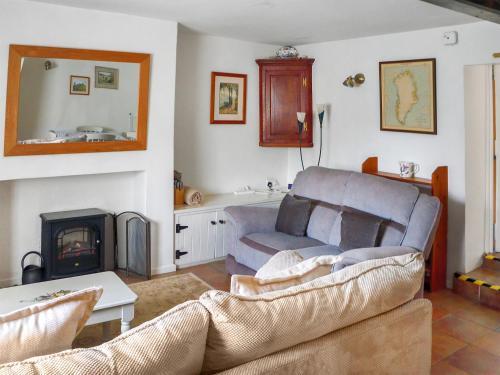 a living room with a couch and a fireplace at Newbiggin Cottage in Richmond