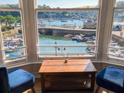 a room with a large window with a view of a harbor at Anchorage View in Dartmouth