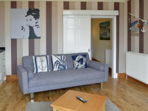 a living room with a couch and a table at Dorn Rock View - Uk33918 in Portpatrick