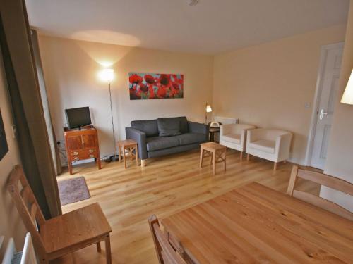 a living room with a couch and a tv at New Bakery in Glanton