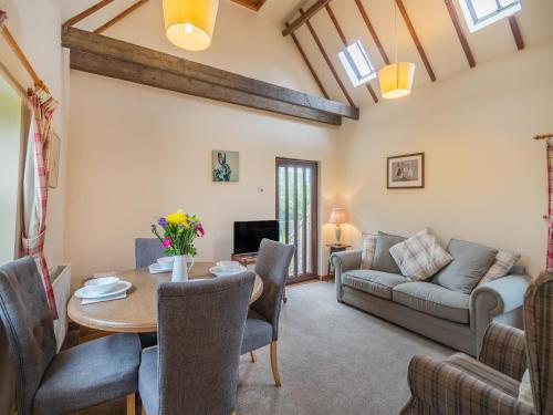 a living room with a table and a couch at The Granary - Uk44490 in Sedgefield
