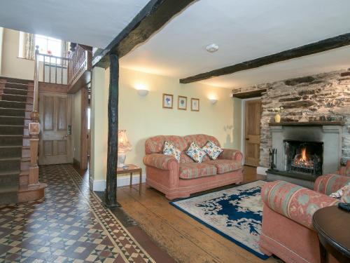 a living room with a couch and a fireplace at The Vicarage in Lowick Green