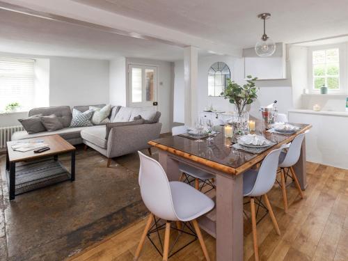 a kitchen and living room with a table and chairs at Hurst Cottage in Sturminster Newton