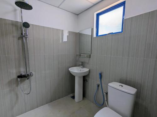 a bathroom with a shower and a toilet and a sink at Prince Cottage - Entire Private Cottage in Kesbewa