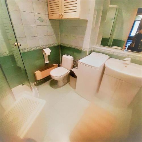 a bathroom with a toilet and a sink at Let's go back to the memories in Krakow