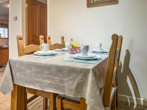 a dining room table with a table cloth on it at Heron's Lodge in Llanarthney