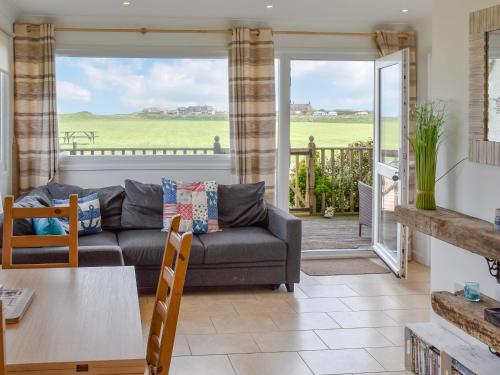 a living room with a couch and a table at On The Beach in Bacton