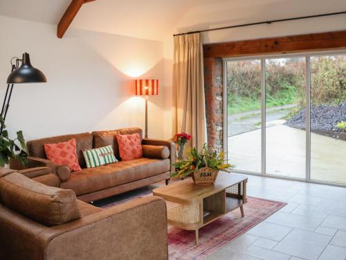a living room with a couch and a table at Stables in Carmarthen