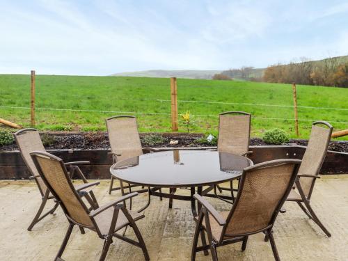 a table and chairs with a view of a field at Stables in Carmarthen