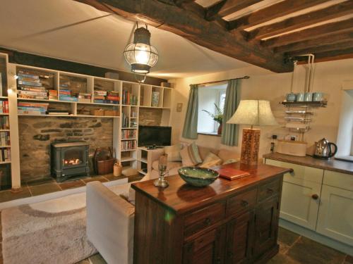 a living room with a couch and a fireplace at Penroc in Pentre-briwnant