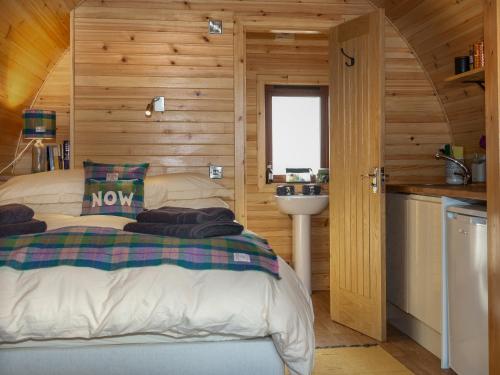 a bedroom with a bed and a sink in a cabin at Now - Uk50567 in Port of Menteith