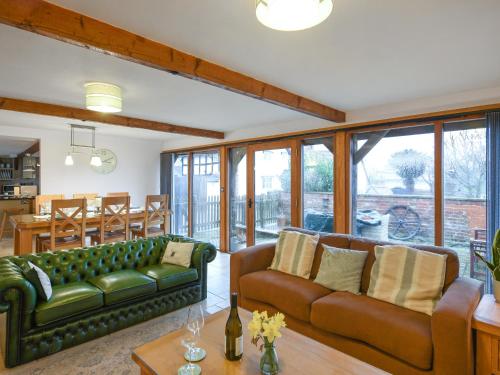 a living room with a couch and a table at Lower House Barn in Staunton on Wye