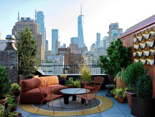 a balcony with a couch and chairs and a table at The Manner, The Unbound Collection by Hyatt in New York