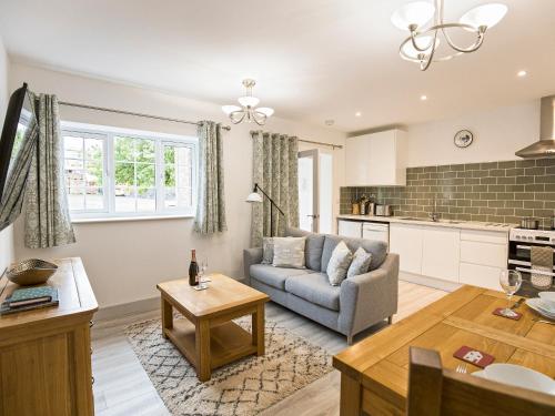 a living room with a couch and a table at Foxwhelp in Ledbury