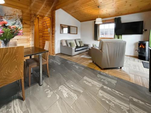 a living room with a table and a couch at Lodge 4 - Uk51264 in Glasgow