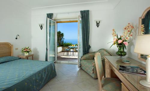 a bedroom with a bed and a couch and a table at Da Gelsomina in Anacapri