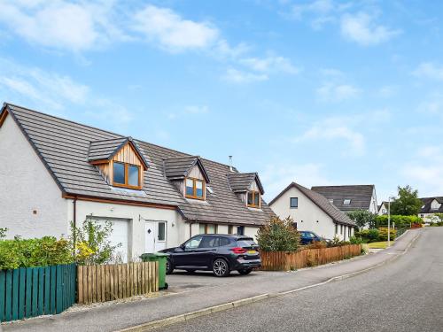 a black car parked in front of a house at Beinn View House in Cononbridge
