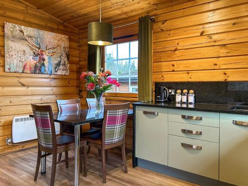 a dining room with a table and chairs in a kitchen at Lodge 5 - Uk51251 in Glasgow