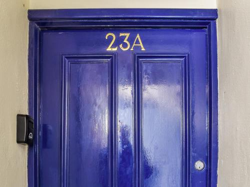 a blue door with the number on it at The Snug in Bowness-on-Windermere