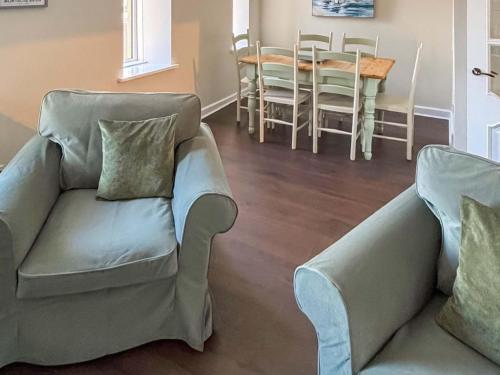 a living room with a couch and a dining room at India Lane Cottage in Montrose