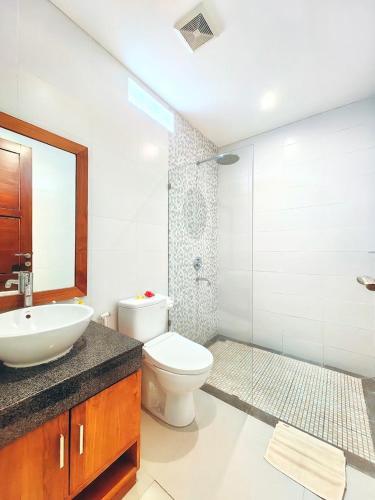 a bathroom with a toilet and a sink and a shower at ThreeWin Homestay in Ubud