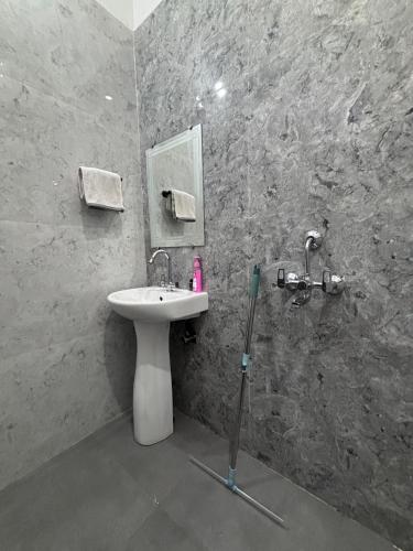 a bathroom with a sink and a mirror at Whispering Vines by Blessings in Rishīkesh
