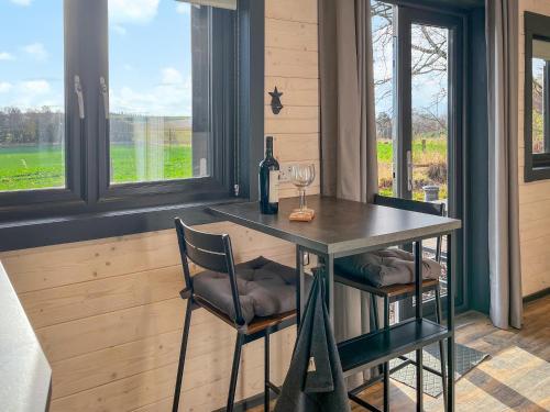 a room with a table and two chairs and a window at Barn Owl Cabin - Uk45401 in Forfar