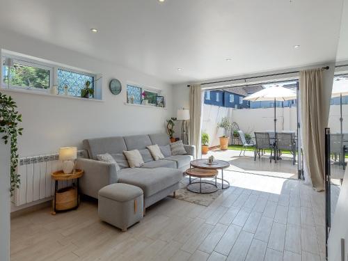a living room with a couch and a table at Olive Breeze in Felixstowe