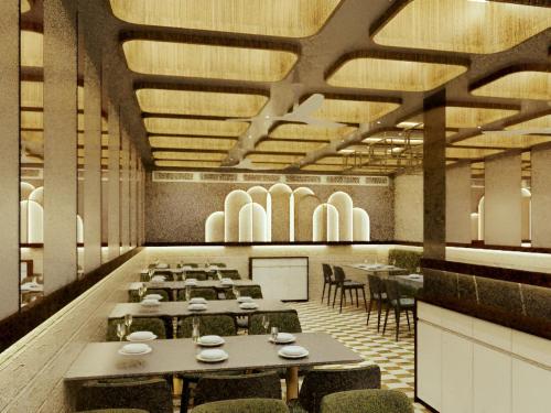 a restaurant with tables and chairs in a room at GREEN WAY HOTEL & RESTAURANt in Gangānagar