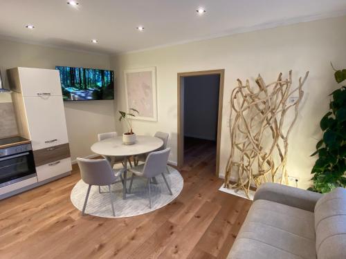 a living room with a table and chairs at Cozy apartment in Irrel in Irrel
