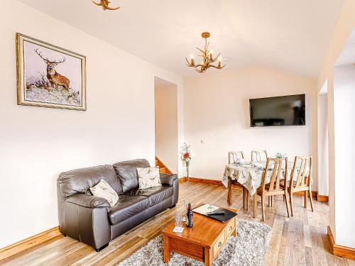 a living room with a couch and a table at Water's Edge - Uk32390 in Dunford Bridge