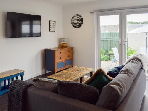 a living room with a couch and a table at The Rest in St. Andrews