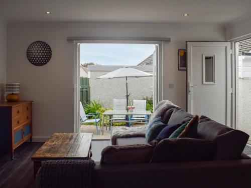 a living room with a couch and a table and an umbrella at The Rest in St. Andrews